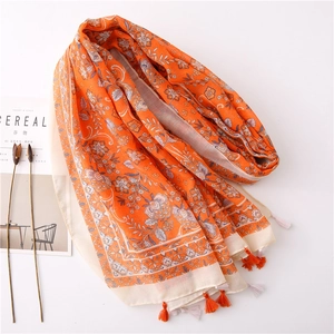 Detail of vintage orange floral cotton linen scarf with elegant fringe and floral patterns