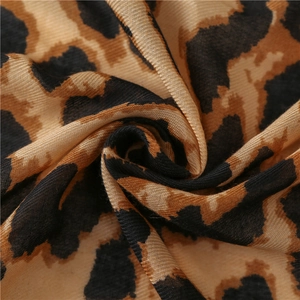 Macro shot of leopard print scarf fabric showing the detailed weave and soft texture