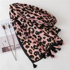 Detail of pink leopard print scarf featuring soft cotton-feel fabric and long tassels