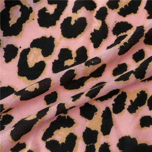 Close-up of pink leopard print scarf fabric showing soft texture and tassel details