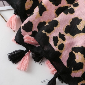 Close-up of pink leopard print scarf showing soft woven texture and fringe details