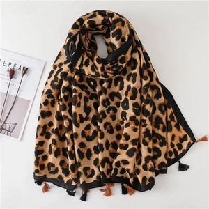 Close-up of leopard print scarf featuring soft fabric and bicolor fringe tassels