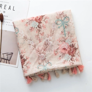 Close-up of floral print cotton linen scarf with pink fringe tassels and retro patterns