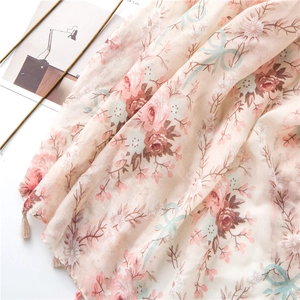 Detail of floral cotton linen scarf with pink roses, daisies and fringe tassels