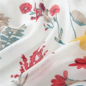 Close-up of lightweight linen cotton fabric with vibrant floral prints and tassels