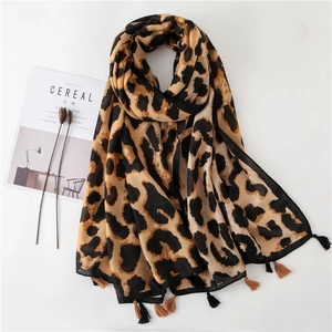 Long leopard print scarf with fringe tassels on white background with cereal magazine