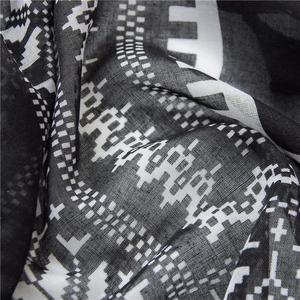 Detail of soft black and white geometric pattern scarf with refined fringe texture