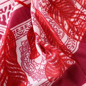 Close-up of red and white ethnic floral pattern on breathable linen texture scarf