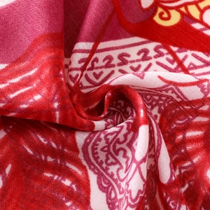 Close-up of red and pink paisley pattern on lightweight cotton linen scarf fabric