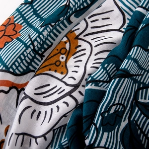Close-up of floral print cotton linen scarf with detailed texture and draped fabric