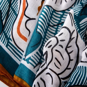 Close-up of linen-feel scarf fabric showing abstract floral print and soft texture