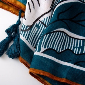 Detailed macro view of ethnic floral printed scarf with fine tassel fringe craftsmanship
