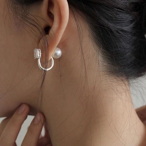 Elegant square zircon and pearl drop earrings in silver finish worn by a model