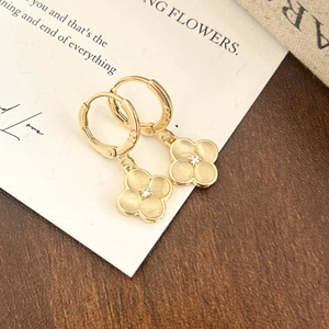 Close-up of S925 cat eye stone flower earrings with zircon center and gold finish