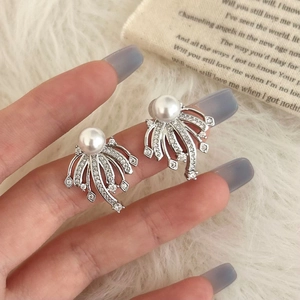 Detail of fan-shaped silver earrings with white pearl and micro-pave cubic zirconia accents
