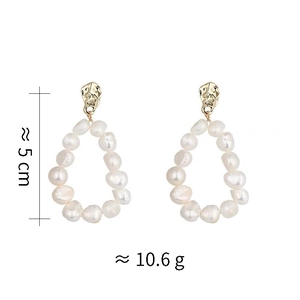 Detailed view of handmade pearl drop earrings with gold textured studs and sizing info