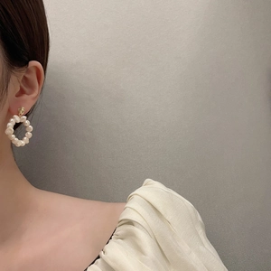 Elegant 18K gold plated hoop earrings with handmade natural freshwater pearls on a model