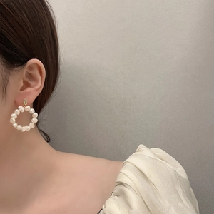 Vintage freshwater pearl hoop earrings with 18K gold plating on elegant female model