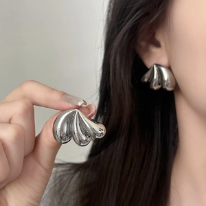 Polished silver metal teardrop earrings with a modern layered shell design for women