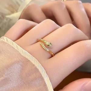 Elegant gold snake-shaped open ring with cubic zirconia stones worn on a hand