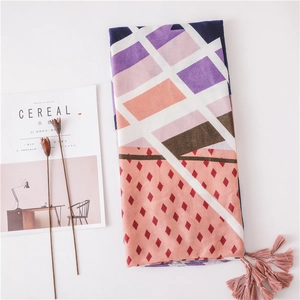 Colorful geometric linen scarf with pink tassels and vibrant purple and orange patterns
