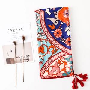 Bohemian mandala print scarf in navy and orange with red tassels for beach travel