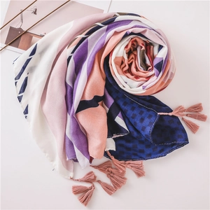 Colorful geometric cotton linen scarf with pink tassels in a spiral flat lay display