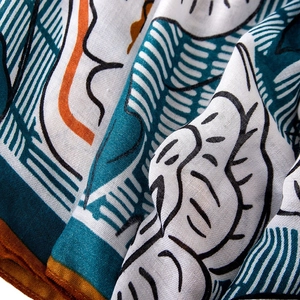 Linen feel floral scarf with abstract blue and orange print and fringed edges