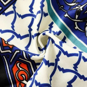 Macro shot of Thai style cotton linen scarf showing blue geometric and orange totem patterns