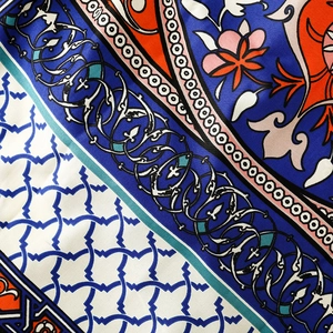 Detailed close-up showing the premium twill texture and ethnic floral print of the scarf