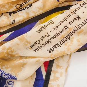 Close-up of vintage postal print cotton scarf with elegant script and postage stamp detail
