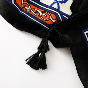 Close-up of geometric totem patterns and black tassels on cotton linen scarf