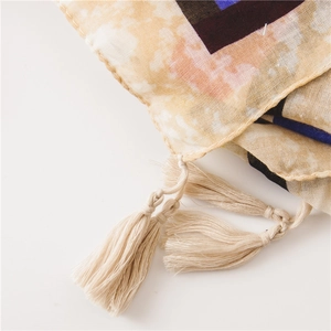 Detailed close-up of cotton linen scarf featuring fine tassel fringe and hem stitching