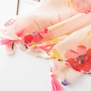 Detail of pink floral scarf showing sheer cotton-linen fabric and tassel corner trim
