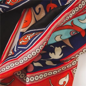 Detailed close-up of bohemian ethnic print scarf with vibrant blue and red patterns