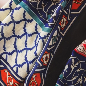 Macro shot of ethnic pattern cotton linen scarf showing soft fabric folds and prints