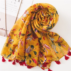 Ethnic floral cotton scarf in yellow with red tassels, perfect for summer beach sun protection