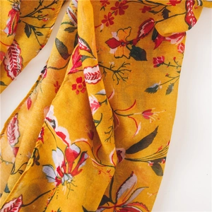 Detailed view of yellow floral pattern on breathable linen cotton scarf fabric
