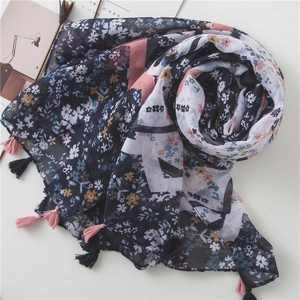 Navy blue cotton linen floral scarf with pink tassel edges on a white background