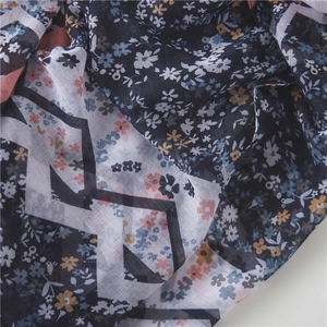 Detail of navy blue floral scarf with light semi-transparent texture and soft drapes
