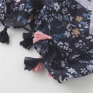 Close-up of navy blue floral cotton linen scarf featuring delicate fringe tassels details