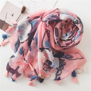 Pink and blue floral cotton linen scarf with tassels displayed on white background