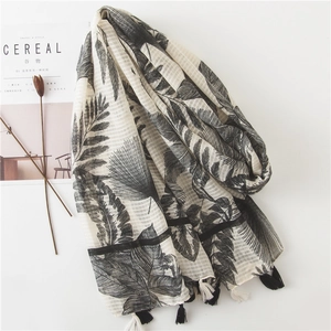 Minimalist cotton linen scarf with tropical leaf pattern and fringe for beach vacation