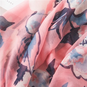 Detail of pink and blue floral print scarf showing lightweight fabric and soft texture