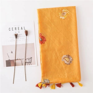 Ethnic yellow cotton linen scarf with paisley embroidery and tassel trim for travel