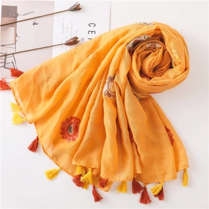 Ethnic embroidered cotton linen scarf in bright orange with floral patterns and tassels