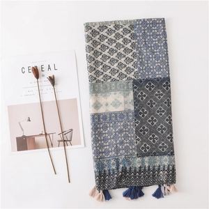 Detail of plaid cotton linen scarf featuring bohemian patterns and bicolor tassels
