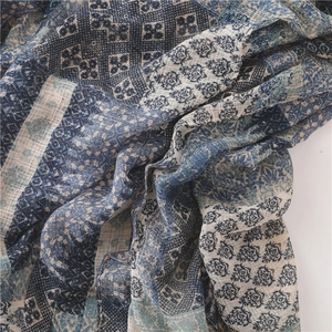 Detail of blue and white bohemian plaid scarf showing breathable linen texture and patterns