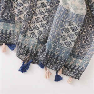 Detail of bohemian plaid linen scarf showing intricate patterns and bicolor tassels