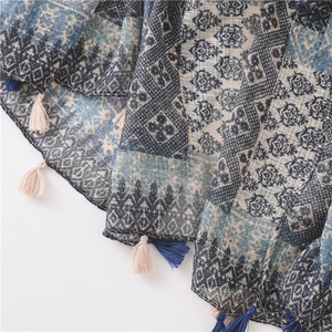 Close-up of bohemian plaid cotton linen scarf with geometric patterns and fringe